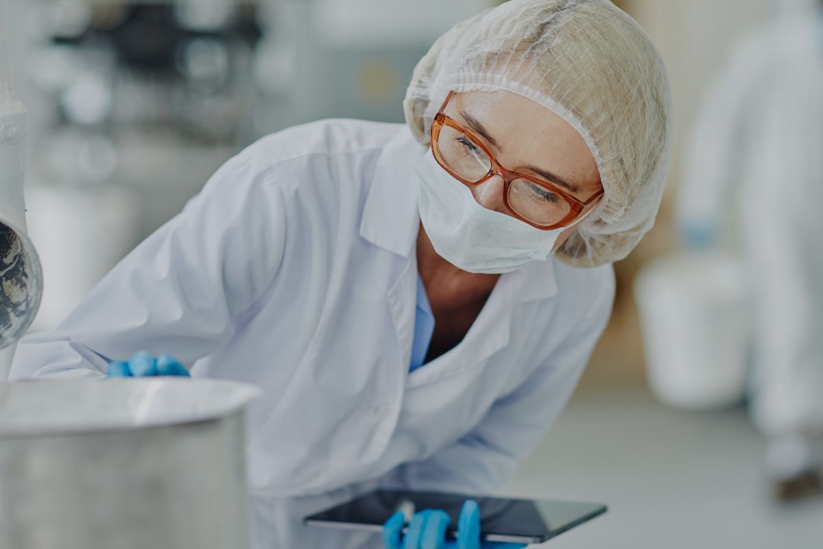 Scientist wearing protective lab clothing during supplement quality control and testing