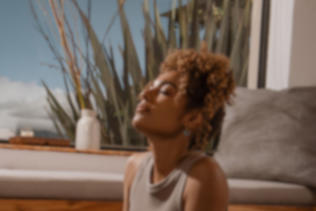 Woman relaxing in natural light as part of a calm daily wellness and supplement routine