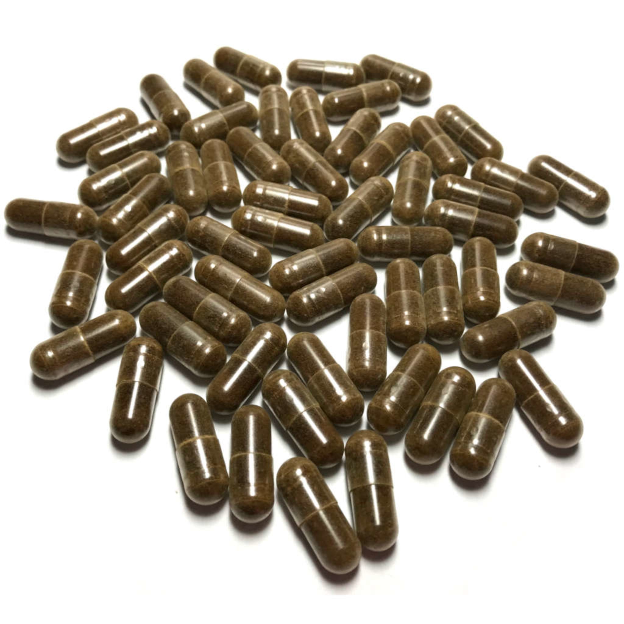 Brown capsules scattered on a white background